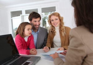 Family signing real-estate contract