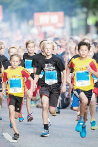 STOCKHOLM - AUG, 16: After the start with tree young kids running in the Midnight Run for children (Lilla Midnattsloppet) event. Aug 16, 2014 in Stockholm, Sweden